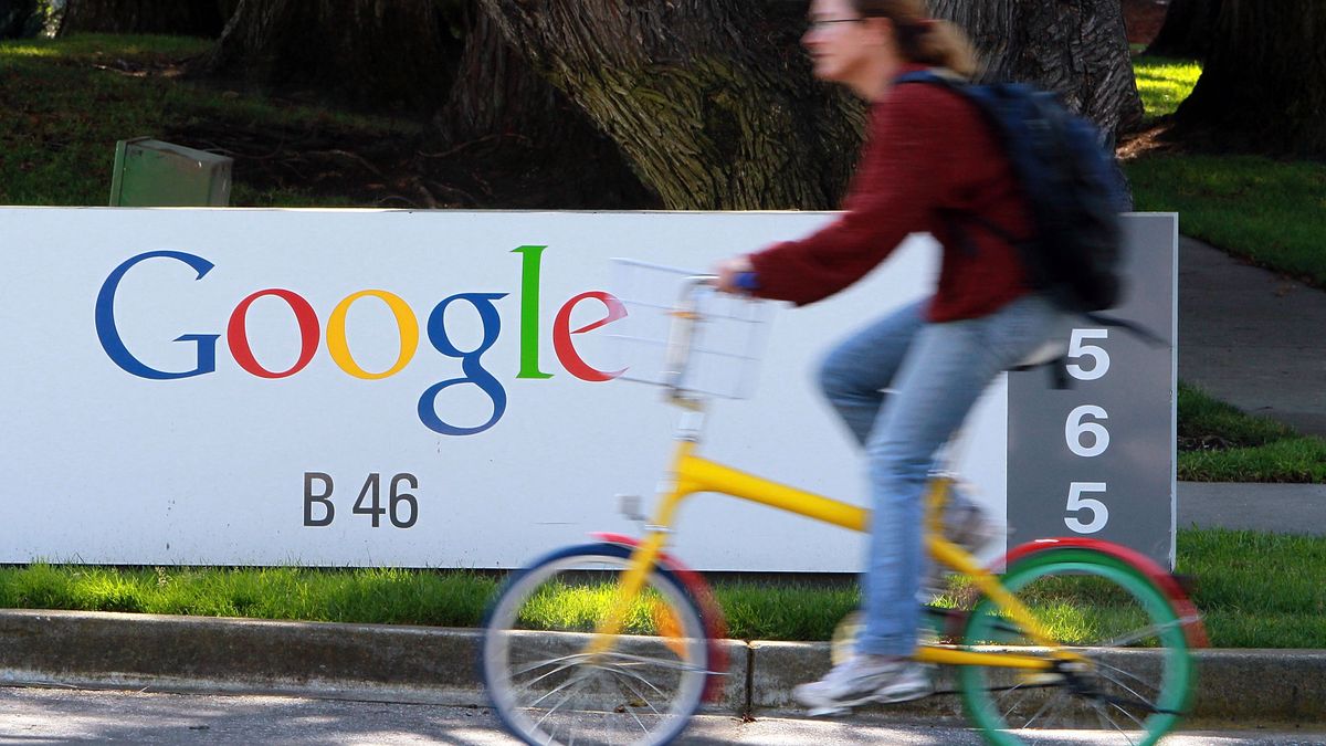 A bicyclist rides by a sign at the Google headquarters March 10, 2010 in Mountain View, California.